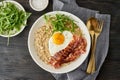 Oatmeal, fried egg and fried bacon. Balance of proteins, fats, carbohydrates. Close up