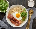 Oatmeal, fried egg and fried bacon. Brutal man sport breakfast. Hearty fat high-calorie breakfast