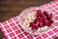 Oatmeal with frozen cherry with cup of coffee on wooden background Royalty Free Stock Photo