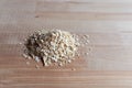 Oatmeal grains on wooden desk. Bright and natural light and shad