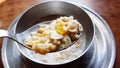 Oatmeal and granola with milk for breakfast