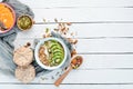 Oatmeal with kiwi and pumpkin seeds.