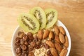 Oatmeal with kiwi raisins and almonds. Neutral background Royalty Free Stock Photo
