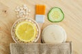 Oatmeal, lemon and cucumber slice, soap bar and make-up brush. Ingredients for preparing homemade mask. Natural beauty treatment Royalty Free Stock Photo