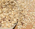 Oatmeal lying in a plate and scattered on a wooden table