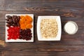 Oatmeal with milk and dried fruit. Useful and healthy breakfast. dark wooden background, top view Royalty Free Stock Photo