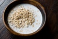 Oatmeal with Milk in Wooden Bowl / Plain Porridge