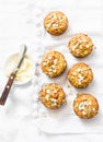 Oatmeal mini muffins with apricots, apples, carrots and nuts on light background, top view.