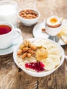 Oatmeal with nuts and jam, soft boiled eggs, selective focus, si