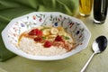 Oatmeal with orange honey, banana and apple. Delicious breakfast menu