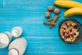 Oatmeal porridge with banana, kiwi fruit, nuts and honey in a bowl with egg for healthy breakfast on rustic wooden Royalty Free Stock Photo