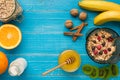 Oatmeal porridge with banana, kiwi fruit, nuts and honey in a bowl with egg for healthy breakfast on rustic wooden Royalty Free Stock Photo