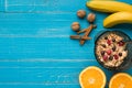 Oatmeal porridge with banana, kiwi fruit, nuts and honey in a bowl with egg for healthy breakfast on rustic wooden Royalty Free Stock Photo