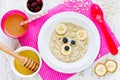 Oatmeal porridge bear with honey banana and berries, fun food ar