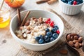 Oatmeal porridge bowl with fruits, nuts and cinnamon in bowl Royalty Free Stock Photo