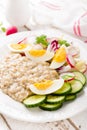 Oatmeal porridge with boiled egg and vegetable salad with fresh radish, cucumber and lettuce. Healthy dietary breakfast Royalty Free Stock Photo