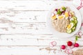 Oatmeal porridge with boiled egg and vegetable salad with fresh radish, cucumber and lettuce. Healthy dietary breakfast Royalty Free Stock Photo