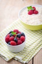 Oatmeal porridge in bowl with berries raspberries and blackberri Royalty Free Stock Photo