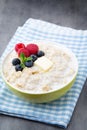 Oatmeal porridge in bowl with berries raspberries and blackberri Royalty Free Stock Photo