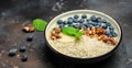 Oatmeal porridge in a bowl with fresh blueberries and nuts on a dark table. Healthy breakfast. Super food healthy eating Royalty Free Stock Photo