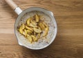 Oatmeal porridge with caramelized apples and cinnamon in a saucepan on a wooden table, top view Royalty Free Stock Photo