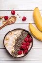 Oatmeal porridge with chia seeds, berries and banana.smoothie bowl with granola in a coconut bowl, top view. Healthy vegan food Royalty Free Stock Photo