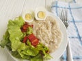 Oatmeal porridge egg dietary salad natural rustic Royalty Free Stock Photo