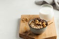 Oatmeal porridge with nuts, chocolate in a gray bowl, a glass of milk. Breakfast, healthy food.Copy space. Good morning Royalty Free Stock Photo