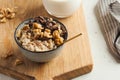 Oatmeal porridge with nuts, chocolate in a gray bowl, a glass of milk. Breakfast, healthy food. Good morning Royalty Free Stock Photo