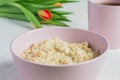 Oatmeal porridge in pink ceramic bowl. healthy breakfast. close up Royalty Free Stock Photo
