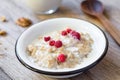 Oatmeal porridge with raspberry and milk, healthy breakfast Royalty Free Stock Photo