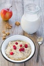 Oatmeal porridge with raspberry and milk, healthy breakfast Royalty Free Stock Photo