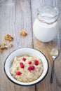 Oatmeal porridge with raspberry and milk, healthy breakfast Royalty Free Stock Photo