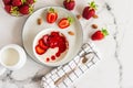 Oatmeal Porridge with Strawberries and almonds in white bowl. Healthy Breakfast with Oatmeal and Fresh Organic Berries Royalty Free Stock Photo