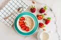 Oatmeal Porridge with Strawberries and almonds in white bowl. Healthy Breakfast with Oatmeal and Fresh Organic Berries Royalty Free Stock Photo