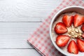 Oatmeal Porridge with Strawberries, Almonds in white bowl. Healthy Breakfast with Oatmeal and Fresh Organic Strawberry. vegan food Royalty Free Stock Photo