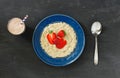 Oatmeal porridge with strawberries and a glass of milkshake