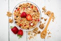 Oatmeal porridge with strawberries and muesli on white wooden background. Flat lay. Top view. Natural breakfast Royalty Free Stock Photo