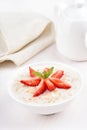 Oatmeal porridge with strawberry slices