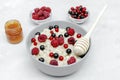 Oatmeal porridge with summer raspberry, currant berries,honey. Porridge oats in bowl with fruits. Healthy food breakfast,lifestyle