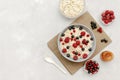 Oatmeal porridge with summer raspberry, currant berries,honey. Porridge oats in bowl with fruits. Healthy food breakfast