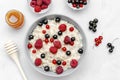 Oatmeal porridge with summer raspberry, currant berries,honey. Porridge oats in bowl with fruits. Healthy food breakfast,lifestyle