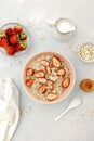 Oatmeal porridge with summer strawberries berries. Porridge oats in bowl with honey,milk,nuts. Healthy food breakfast,lifestyle,