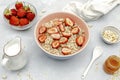 Oatmeal porridge with summer strawberries berries. Porridge oats in bowl with honey,milk,nuts. Healthy food breakfast Royalty Free Stock Photo