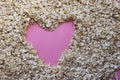 Oatmeal scattered in the middle of a pink heart