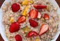 Oatmeal with strawberries, peaches and other fruits.