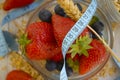 Oatmeal, strawberry, blueberry measuring tape close-up Royalty Free Stock Photo