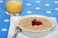 Oatmeal with strawberry jam and orange juice Royalty Free Stock Photo