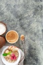 Oatmeal in a white plate with peanut butter, raspberries, apple slices and mint. Near a jar of peanut butter. Coconuts and a spoon Royalty Free Stock Photo