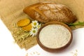 Oatmeal whole grain flour in ceramic bowl, oat spikes, homemade bread and cookies